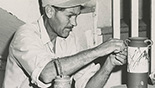 Louis Mideke working on a piece of pottery circa 1958
